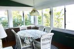 Dining Area in the enclosed porch, just off of the Living Room.  Large windows overlooking Keuka Lake